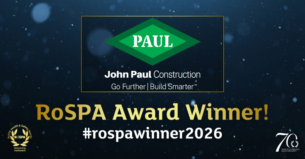 > John Paul Construction graphic announcing "RoSPA Award Winner!" with the 2026 hashtag, company logo, and RoSPA Health & Safety Awards branding on a dark, textured blue background.