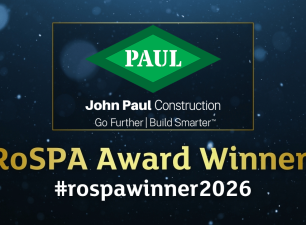 > John Paul Construction graphic announcing "RoSPA Award Winner!" with the 2026 hashtag, company logo, and RoSPA Health & Safety Awards branding on a dark, textured blue background.
