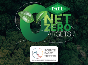 Graphic announcement by John Paul Construction against a dense, aerial background of green forest trees. In the center, a large gradient green number zero features two fresh green leaves resting in the middle. The John Paul Construction "PAUL" diamond logo sits just above bold text reading "NET ZERO TARGETS". Centered below is the official white corporate badge for the "Science Based Targets initiative" containing their wave graphic and the text "Science Based Targets - Driving Ambitious Corporate Climate Action".